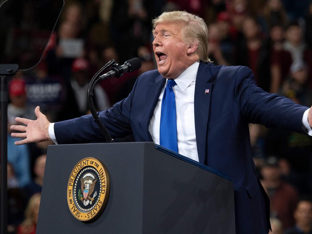 Conspiracy theorists have latched onto President Trump and believe he speaks on coded gestures to them. Picture: SAUL LOEB / AFP.