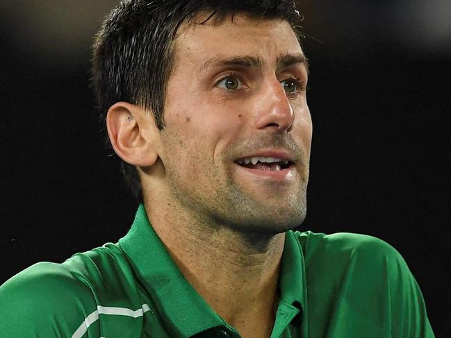 (FILES) This file photo taken on February 2, 2020 shows Serbia's Novak Djokovic reacting after a point against Austria's Dominic Thiem during their men's singles final match on day fourteen of the Australian Open tennis tournament in Melbourne. - Novak Djokovic lost his bid to avoid deportation from Australia on January 16, 2022, with a Federal Court unanimously rejecting his appeal to stay in the country and defend his Australian Open title. (Photo by Greg WOOD / AFP) / -- IMAGE RESTRICTED TO EDITORIAL USE - STRICTLY NO COMMERCIAL USE --