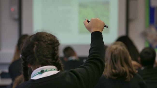 LONDON, ENGLAND - DECEMBER 01:  A student raises her hand in a geography lesson at a secondary school on December 1, 2014 in London, England. Education funding is expected to be an issue in the general election in 2015.  (Photo by Peter Macdiarmid/Getty Images)