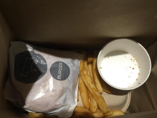 The end result. The burger came wrapped up but the chips had fallen out of their cup. Picture: Elissa Hunt.