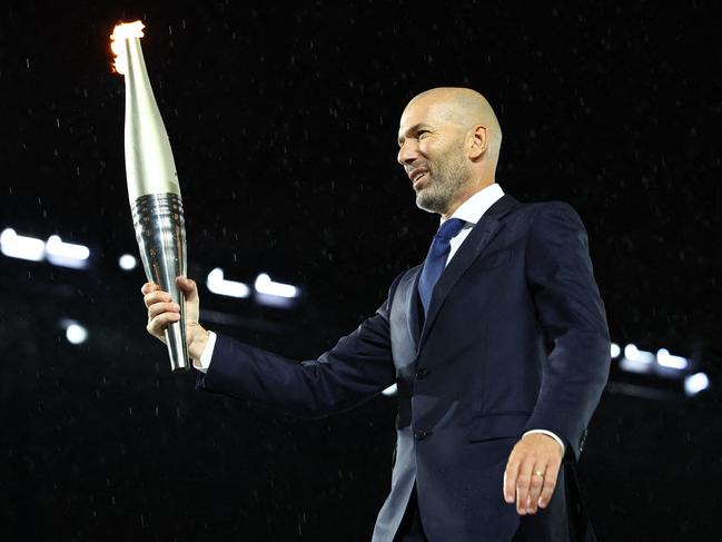 TOPSHOT - Paris 2024 Olympics - Opening Ceremony - Paris, France - July 26, 2024. Torchbearer Zinedine Zidane is seen during the opening ceremony. (Photo by Stephanie Lecocq / POOL / AFP)