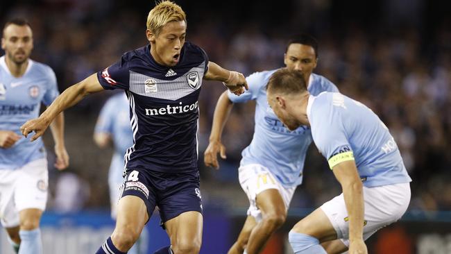 Keisuke Honda takes on Scott Jamieson. Picture: AAP