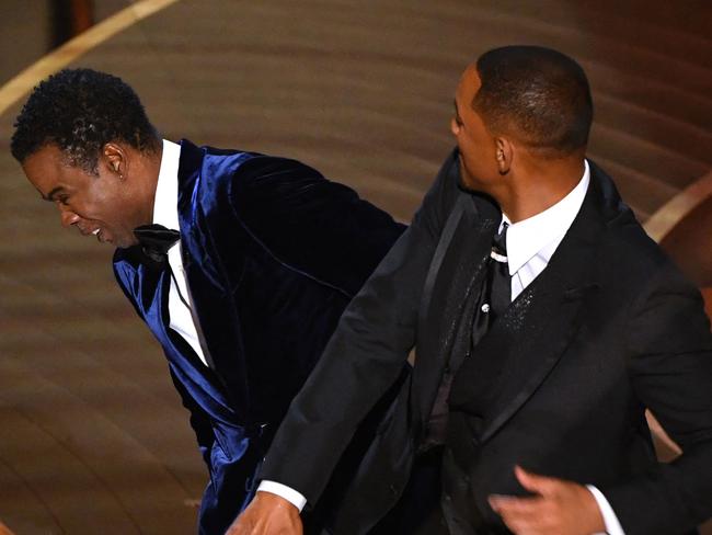 TOPSHOT - US actor Will Smith (R) slaps US actor Chris Rock onstage during the 94th Oscars at the Dolby Theatre in Hollywood, California on March 27, 2022. (Photo by Robyn Beck / AFP)