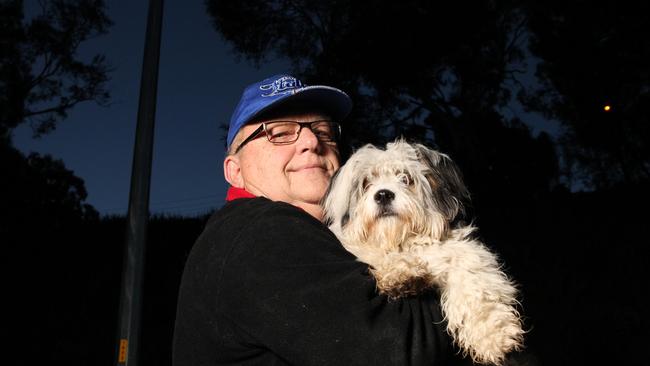 Bruce McIntyre with his dog Zoe says he’s been walking it the “pitch black” for months. Picture: Stephen Laffer