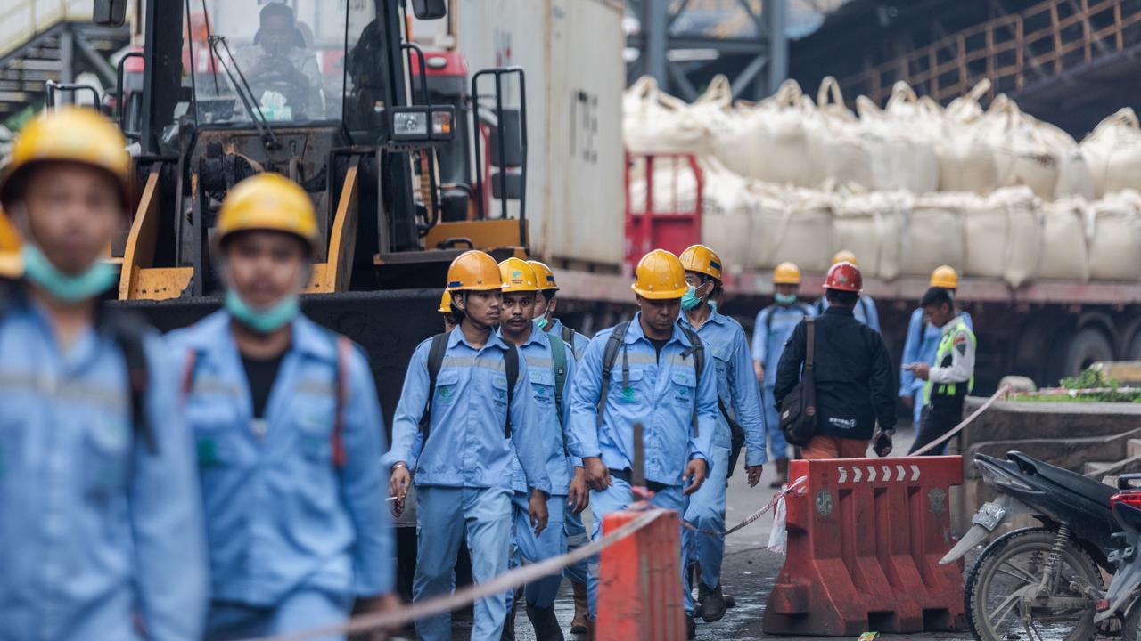 Employees walk during the working shift change near Indonesia Morowali Industrial Park (IMIP) on February 8, 2024, in Morowali, Central Sulawesi, Indonesia. Picture: Garry Lotulung
