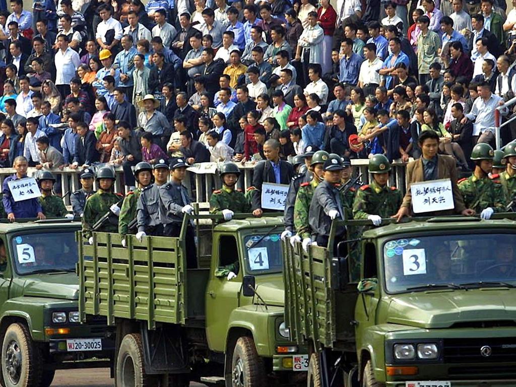 Condemned prisoners who have been sentenced to death for range of crimes from drug trafficking to murder, under guard as they are paraded in front of thousands of people in 2001. Picture: Supplied