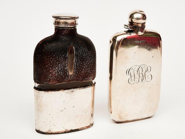 Auction of Bob Hawke & Blanche d'Alpuget Mementos Curiosities Art and Design: Sterling Silver Whiskey Flask Mark of J. D. & S., Sheffield monogrammed ‘B H’, hallmarked, together with a silver plated, leather and glass flask (2). Picture: Supplied