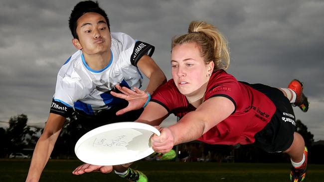 Rachael Mihatsch and Jeffrey Ding compete for the frisbee and enjoy some physical exercise. Picture: Norm Oorloff