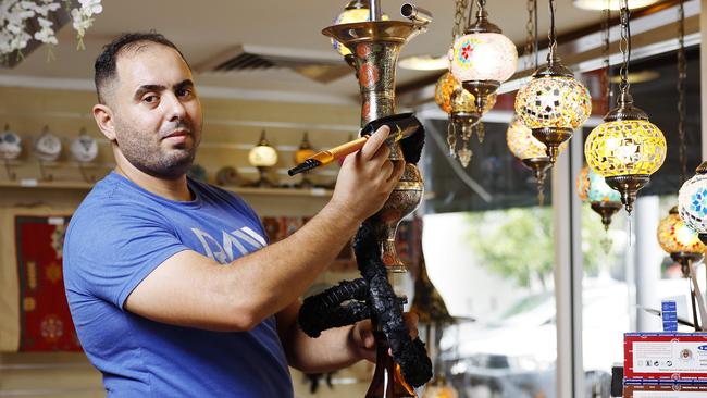 A new convenience store and tobacconist has opened on Lake Street, selling traditional shisha hookah smoking pipes from Iran and Egypt, and lead glass lights from Turkey. Owner of Cairns Convenience Store and Tobacconist Dhyaa Al-Mazkuri with one of the smoking pipes for sale. Picture: Brendan Radke