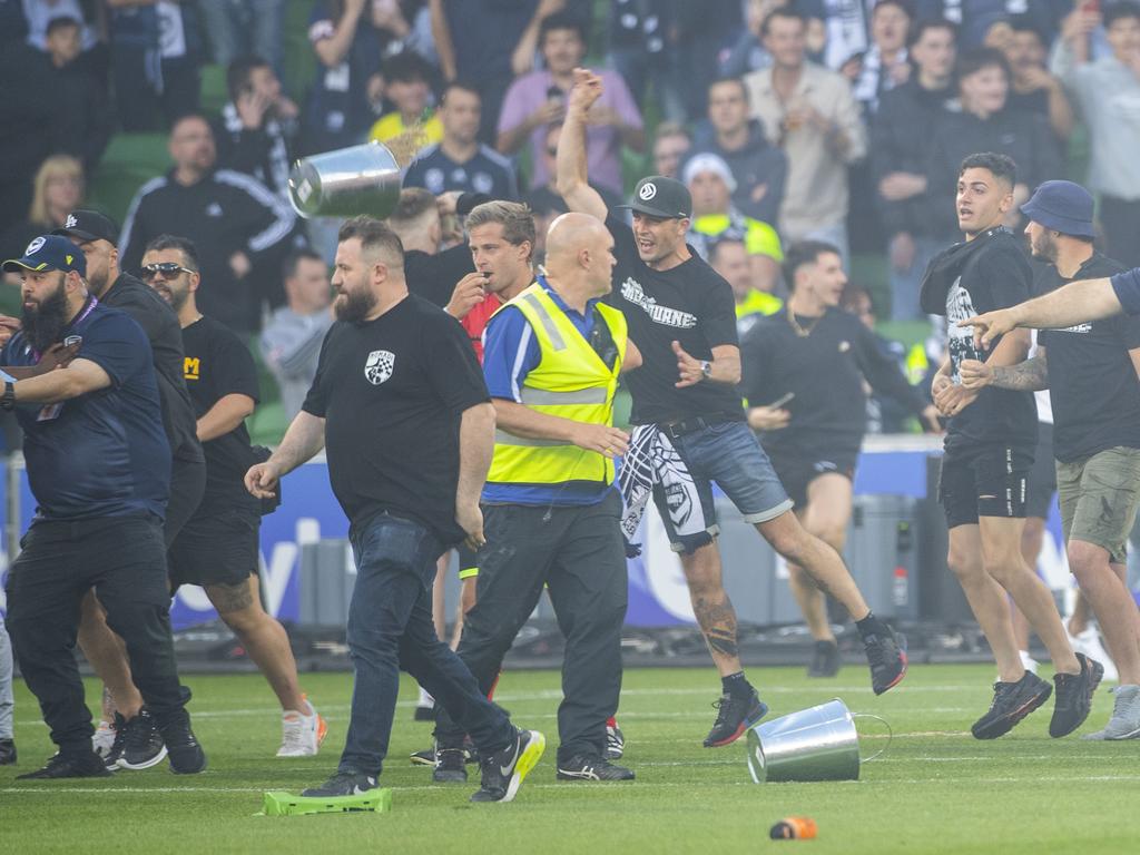 Melbourne Victory fans invade the pitch at AAMI Park.