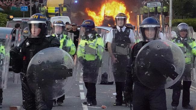 SOUTHPORT, ENGLAND - JULY 30: Riot police hold back protesters after disorder broke out on July 30, 2024 in Southport, England. Rumours about the identity of the 17-year-old suspect in yesterday's deadly stabbing attack here have sparked a violent protest. According to authorities and media reports, the suspect was born in Cardiff to Rwandan parents, but the person cannot be named due to his age. A false report had circulated online that the suspect was a recent immigrant who crossed the English Channel last week and was "on an MI6 watchlist." (Photo by Getty Images/Getty Images)