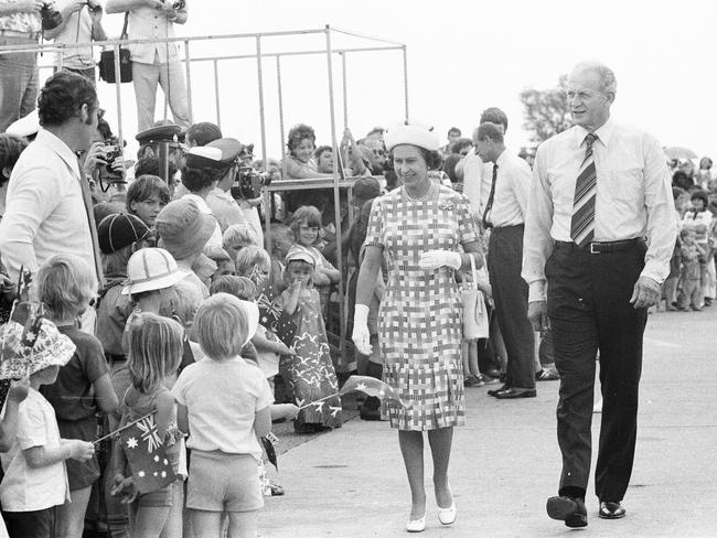 Families lines the streets to catch a glimpse of their Royal Majesty. The Queen is pictured with Former Administrator of the Northern Territory John England.