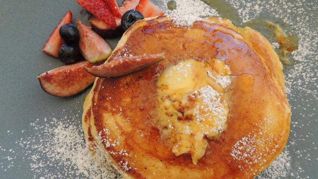 Ricotta pancakes with banana, housemade honeycomb butter, maple syrup and fruit ($12).