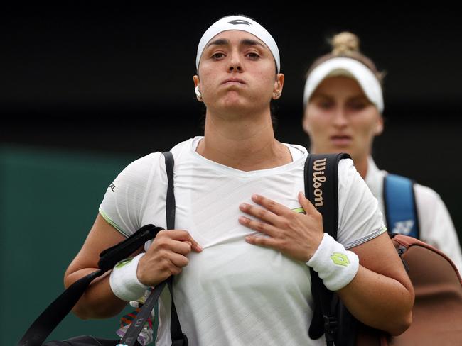 Tunisia's Ons Jabeur (front) and Czech Republic's Marketa Vondrousova enter the court for their women's singles final. (Photo by Adrian DENNIS / AFP)