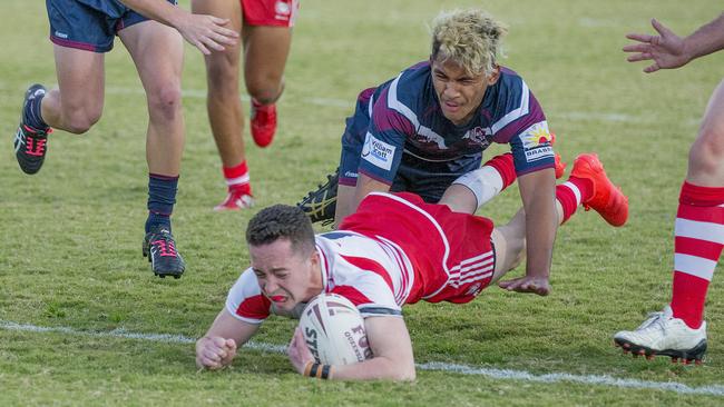 Defending champions Palm Beach Currumbin (red) host runners up Ipswich State High in the opening round of the 2020 Langer Cup at Pizzey Park. Palm Beach Currumbin's Tom Weaver crossing over the line and Ipswich State High's Deijion Leugaimafa. Picture: Jerad Williams