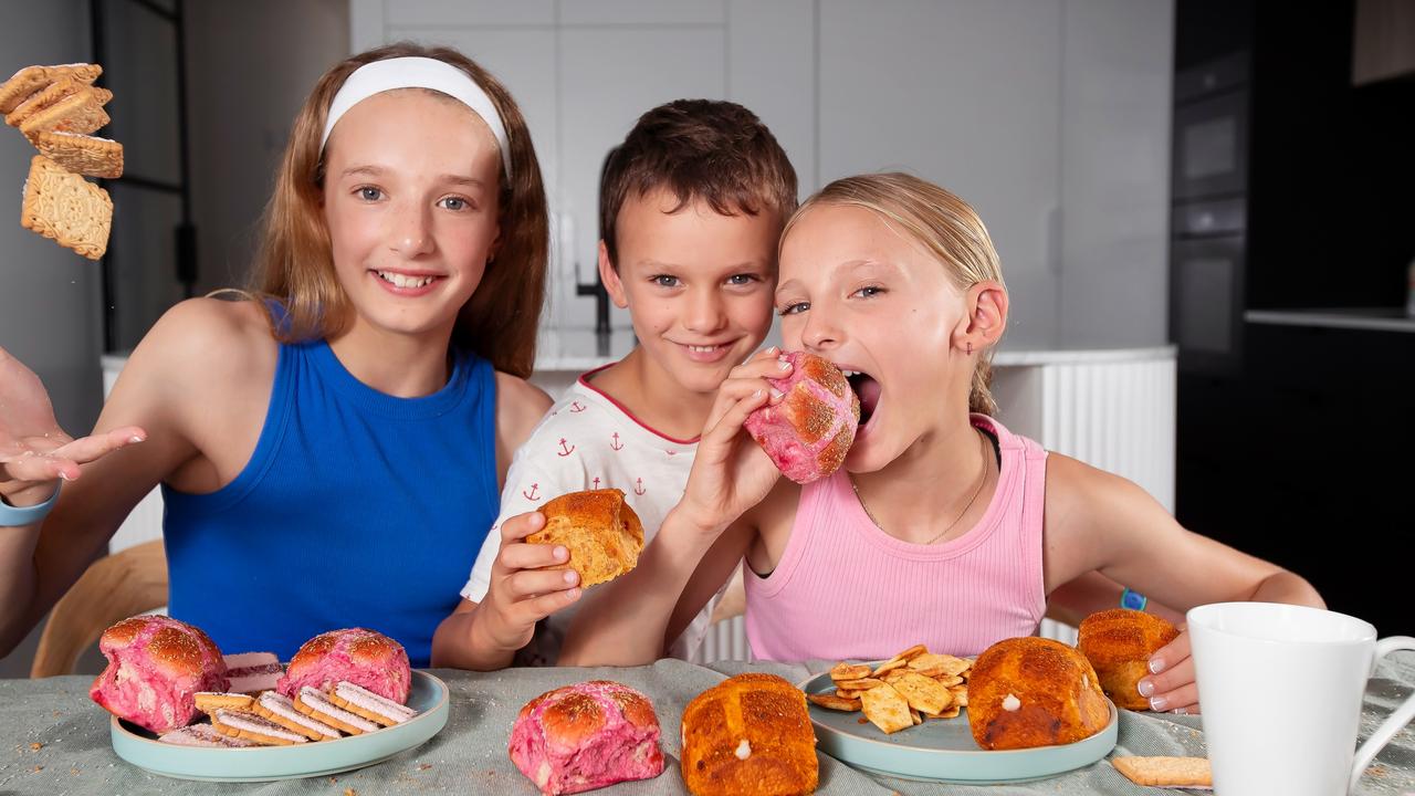 Ella 11, Tommy, 5 and Ava, 9 enjoy the new Iced VoVo hot cross buns. Picture Rebecca Michael.