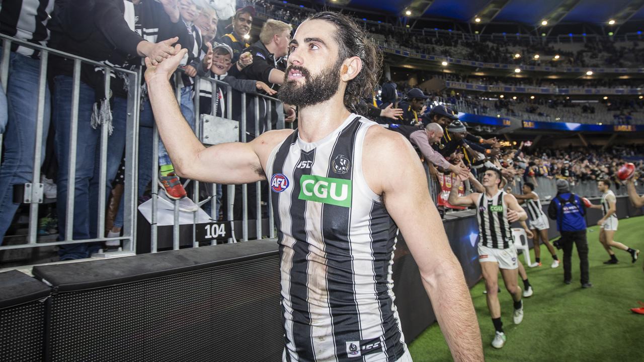 Brodie Grundy celebrates with Collingwood fans after Friday night’s win over West Coast. (AAP Image/Tony McDonough)
