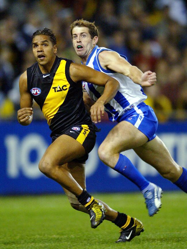 A young Andrew Krakouer, outrunning Troy Makepeace, at the height of his powers in the AFL.