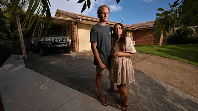 Elly and Ryan Sutherland at their Gold Coast home. Elly is 30 weeks pregnant and will need to return to work sooner due to soaring loan repayments. Picture: Lyndon Mechielsen