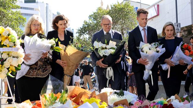 Prime Minister Anthony Albanese and NSW Premier Chris Minns laying flowers at the tribute area at Bondi Junction for the victims of Saturday’s stabbing attacks. Picture: Damian Shaw