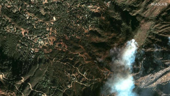 Satellite image shows smoke rising as the Palisades Fire burns close to buildings near Topanga, California. Picture: Maxar Technologies / AFP