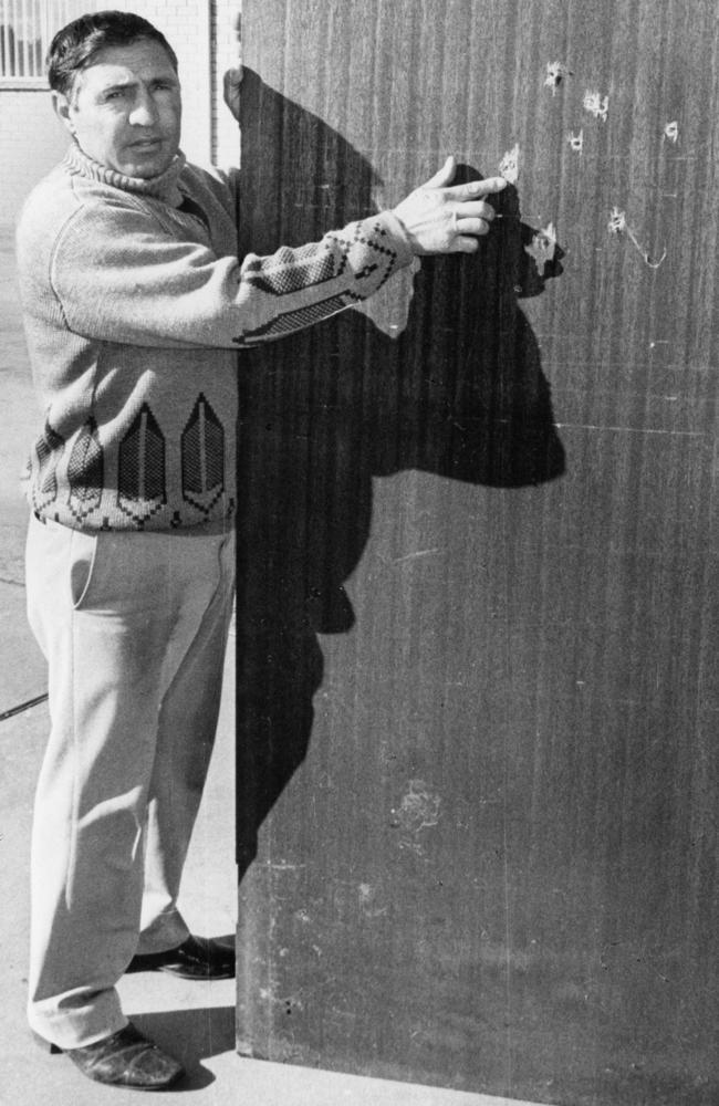 July 1977. Griffith wine grower Tony Sergi points out bullet holes from the 20 plus shots that have been fired at his winery in the past 12 months.