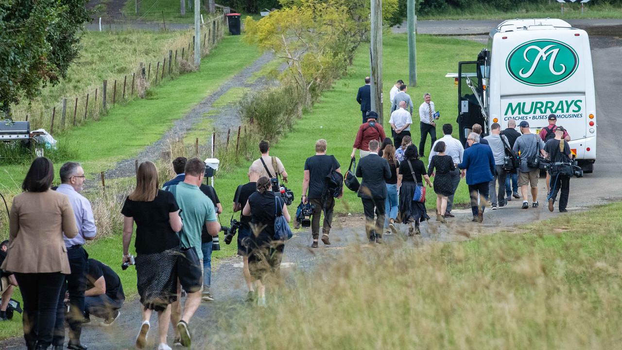 A long line of reporters make their way to the bus. Picture: Jason Edwards