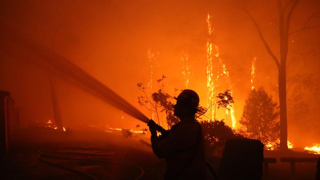 Residents and fireys battle the blaze on Tuesday afternoon. Picture: Rohan Kelly