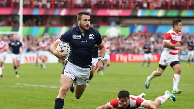 Tommy Seymour of Scotland goes over to score his team’s third try.