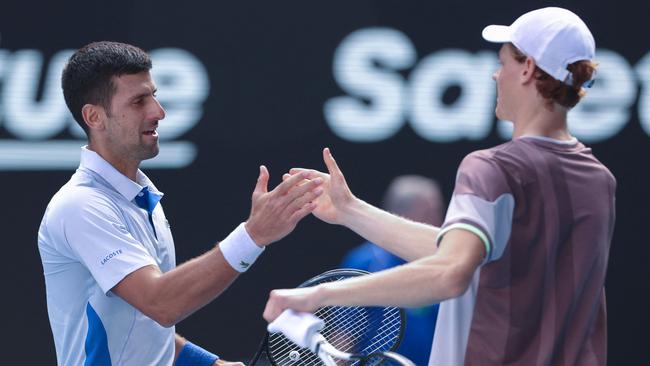 Jannik Sinner and Novak Djokovic greet each other at the net after the former’s win in the Australian Open semi final. Picture: Martin Keep/ AFP.