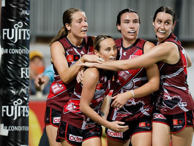 DARWIN, AUSTRALIA - OCTOBER 26: Georgia Gee of the Bombers celebrates a goal with teammates during the 2024 AFLW Round 09 match between the Essendon Bombers and the Richmond Tigers at TIO Stadium on October 26, 2024 in Darwin, Australia. (Photo by Dylan Burns/AFL Photos via Getty Images)