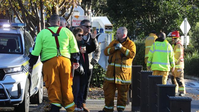 Two of the shop owners talk to CFS volunteers at the scene. Picture: Dean Martin