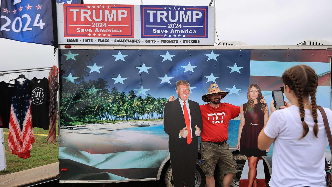 Supporters pose for photographs with cardboard cutouts the former president and first lady in the southern US state of Alabama. Picture: Chip Somodevilla/Getty Images/AFP