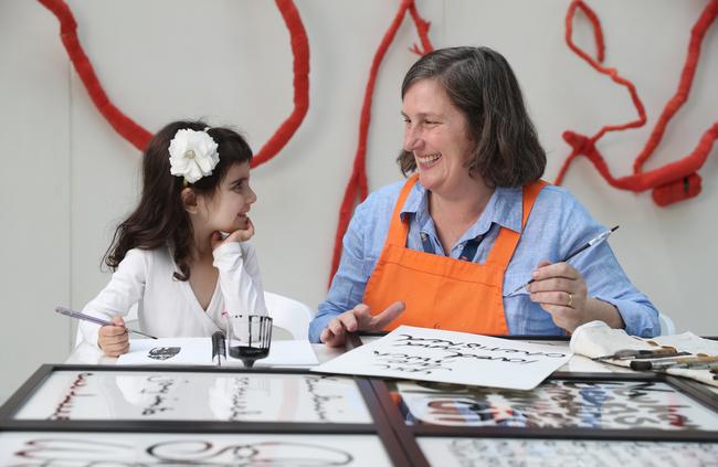 Four-year-old Ariadne works with RPA artist-in-residence Tilly Lees. The artist will be collecting more messages at RPA’s Open Day today. Picture: David Swift.