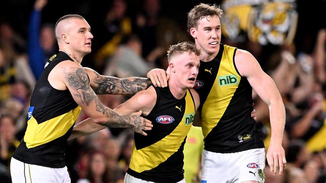 Noah Cumberland celebrates a goal with Dustin Martin and Tom Lynch.