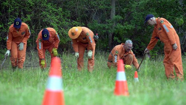 Volunteers search property near the Morley-Clarke home in 2001.