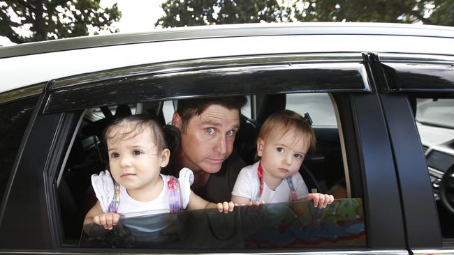 AFL legend Shane Crawford, with his 14-month-old toddlers, is warning parents about the dangers of leaving kids in hot cars. Picture: David Caird