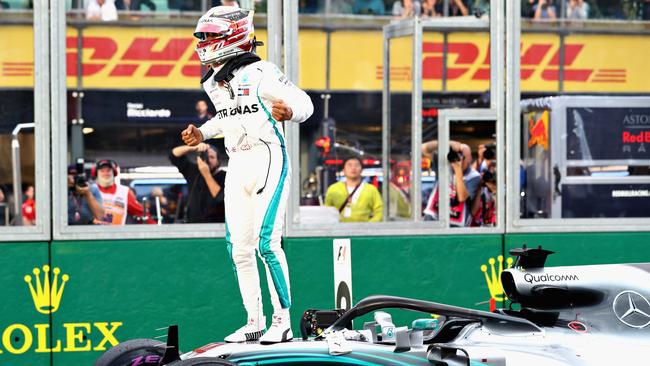 Lewis Hamilton of Great Britain and Mercedes GP celebrates on track after qualifying in pole position during qualifying for the Australian Formula One Grand Prix at Albert Park.