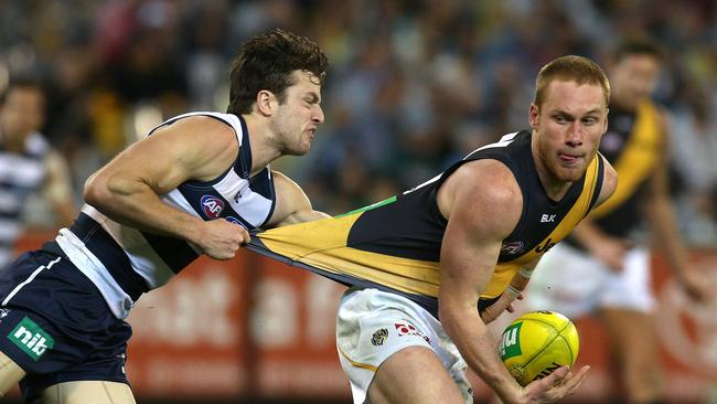 Nick Vlastuin is collared by Jordan Murdoch, with the Cat pouncing on the loose ball to snap a crucial goal. Picture: Wayne Ludbey