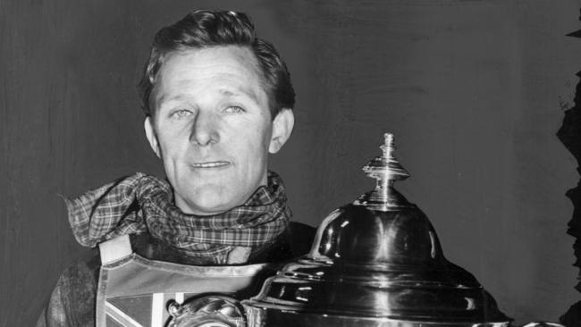 Jack Young carries off the cup after winning the world's speedway championship for the second year in succession at the Empire Stadium Wembley London. The Adelaide-born Young has been inducted into the SA Sport Hall of Fame.