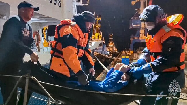 Russian emergency workers carry Mikhail Pichugin ashore after 67 days adrift in the Sea of Okhotsk. Picture: Russian Emergency Ministry Press Service via AP