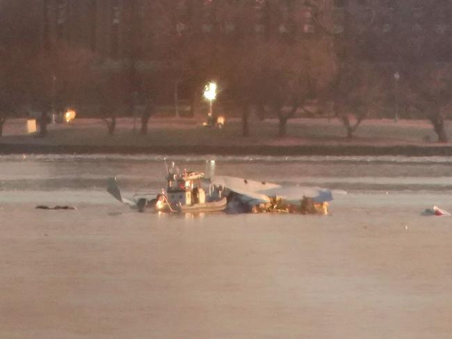 ARLINGTON, VIRGINIA - JANUARY 30: Emergency response units search the crash site of the American Airlines plane on the Potomac River after the plane crashed on approach to Reagan National Airport on January 30, 2025 in Arlington, Virginia. The American Airlines flight from Wichita, Kansas collided with a military helicopter while approaching Ronald Reagan National Airport. Dozens of people are feared to have died in the midair collision.   Andrew Harnik/Getty Images/AFP (Photo by Andrew Harnik / GETTY IMAGES NORTH AMERICA / Getty Images via AFP)