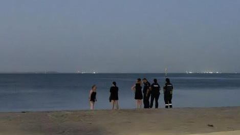 A drone is used to help in the recovery of a pair of paddle boarders at Eastern Beach in Geelong as police speak to concerned people. Photo: Supplied.,