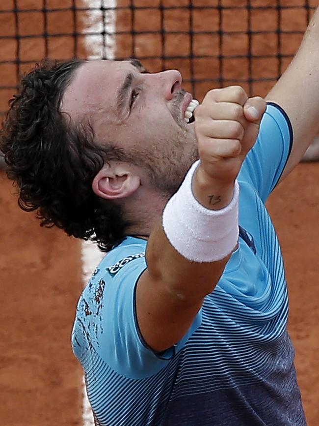 Marco Cecchinato celebrates after defeating Novak Djokovic. Picture: AP.