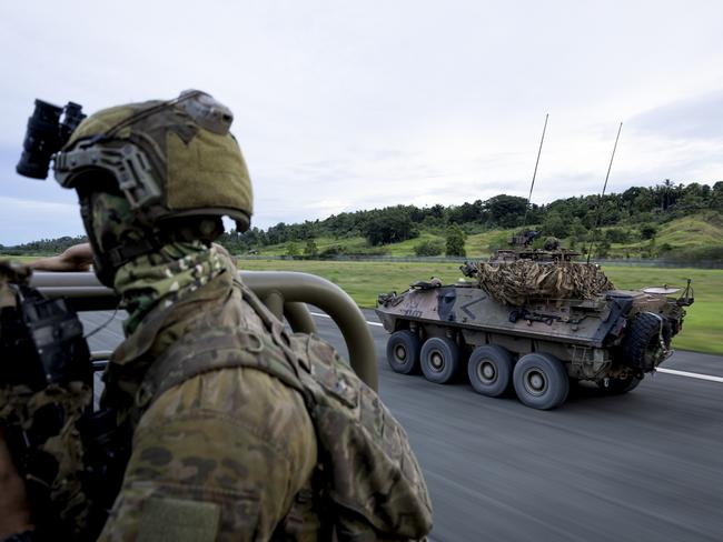 An Australian Army reconnaissance soldier from 3rd Battalion, the Royal Australian Regiment and troopers from 2nd Cavalry Regiment drive down the Wewak Airport runway in an Australian Light Armoured Vehicle (ASLAV) during Exercise Wantok Warrior 24 in Wewak, Papua New Guinea. PHOTO: CPL Brandon Grey