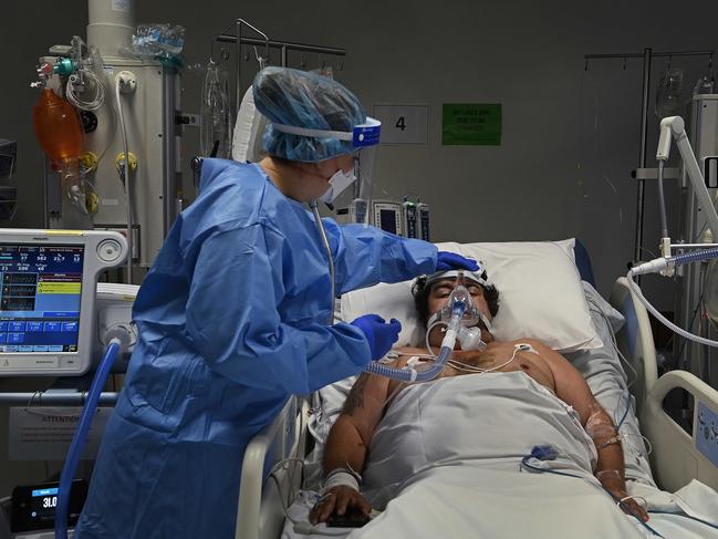 An ICU nurse cares for a COVID-19 patient in St Vincent’s Hospital in Sydney, NSW. Photo: Kate Geraghty