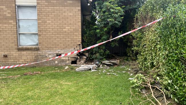 A house next door was also damaged in the bottom corner, with piles of fence left on the grass. Picture: Jack Colantuono