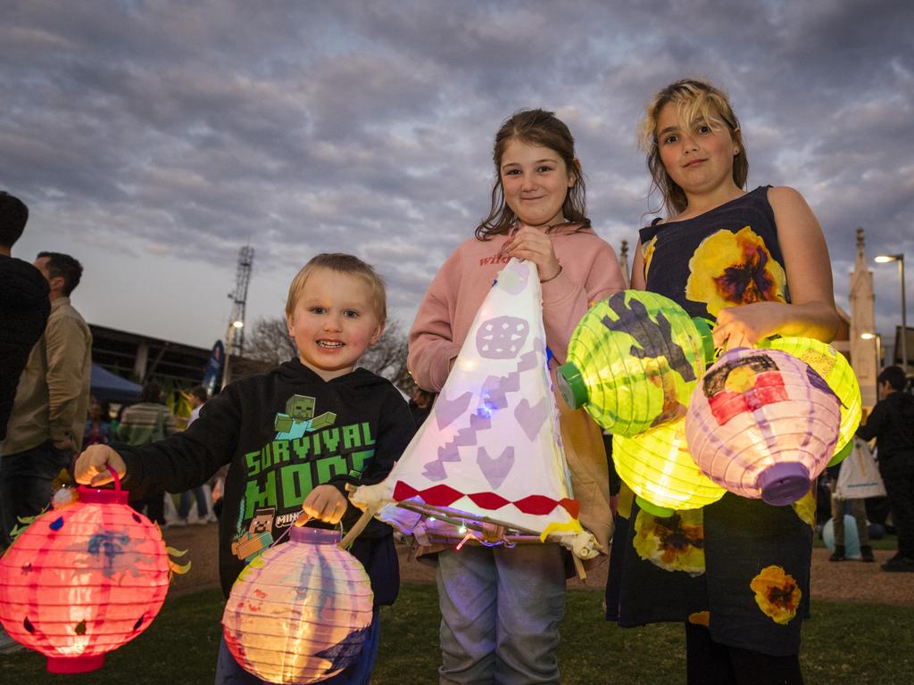 Enjoying Multicultural Australias Luminous Lantern Parade festivities are (from left) Shaun Meddings, Issabelle Hobbs and Khryalea Ingram in the grounds of Empire Theatres, Saturday, August 12, 2023. Picture: Kevin Farmer