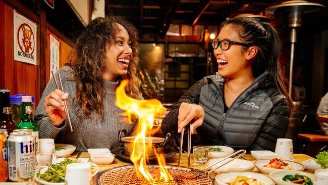 Sasha Mather (left) and Katie Maneesiri enjoying fresh wagyu marbled beef at the Jang Ta Bal Korean Charcoal BBQ restaurant in Strathfield. Picture: Jonathan Ng