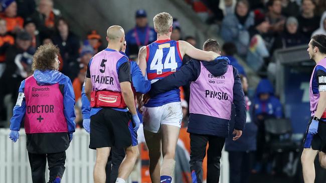 Tim English is helped off after being concussed.